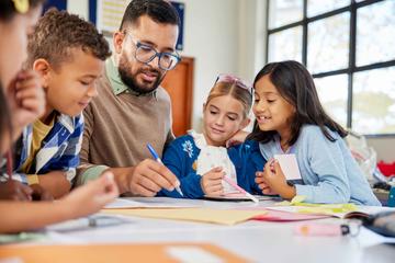 teacher working with students