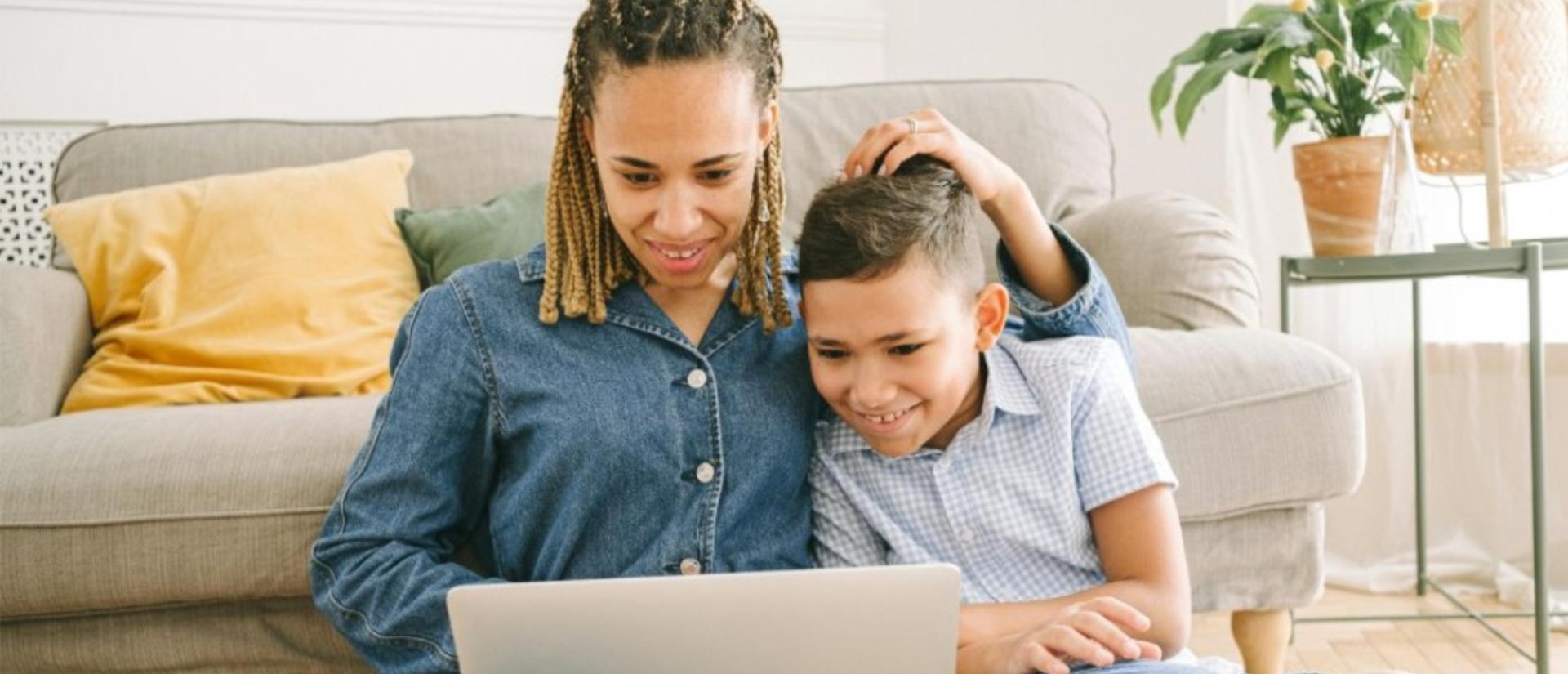mom and child reading on a computer